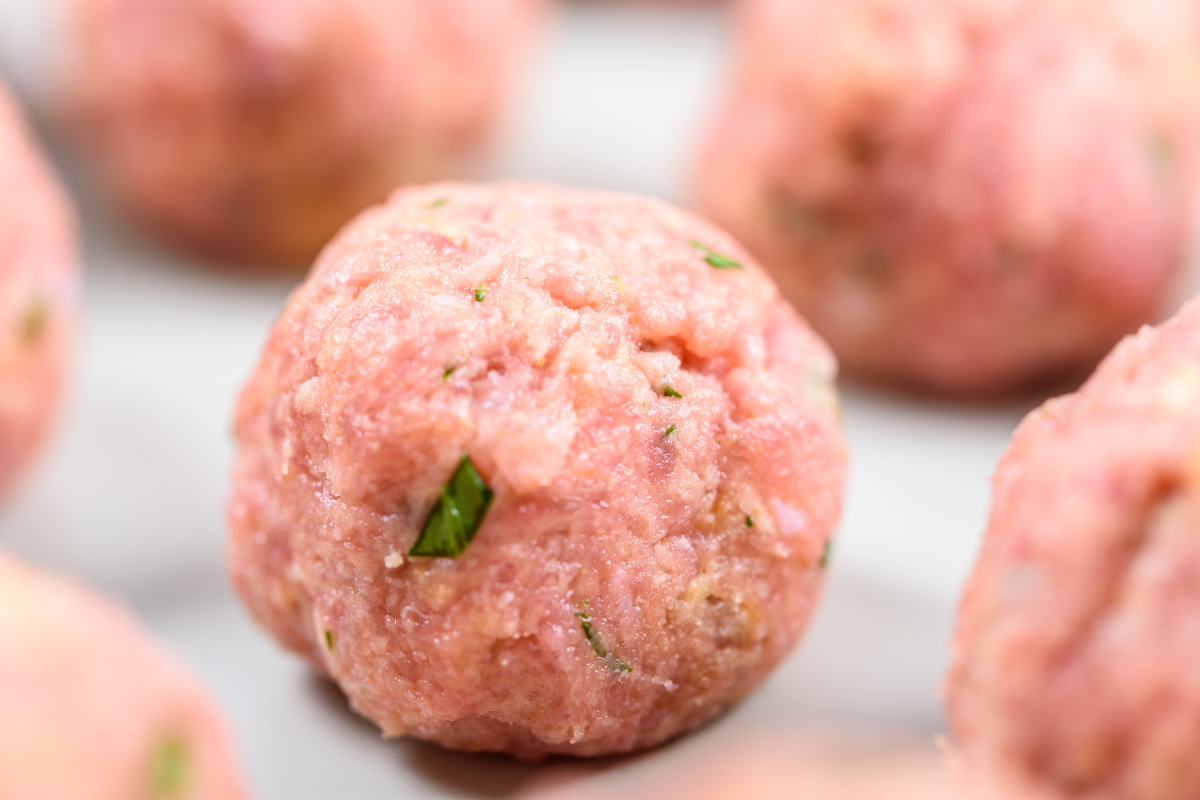 Chicken mince meatballs on a wooden cutting board