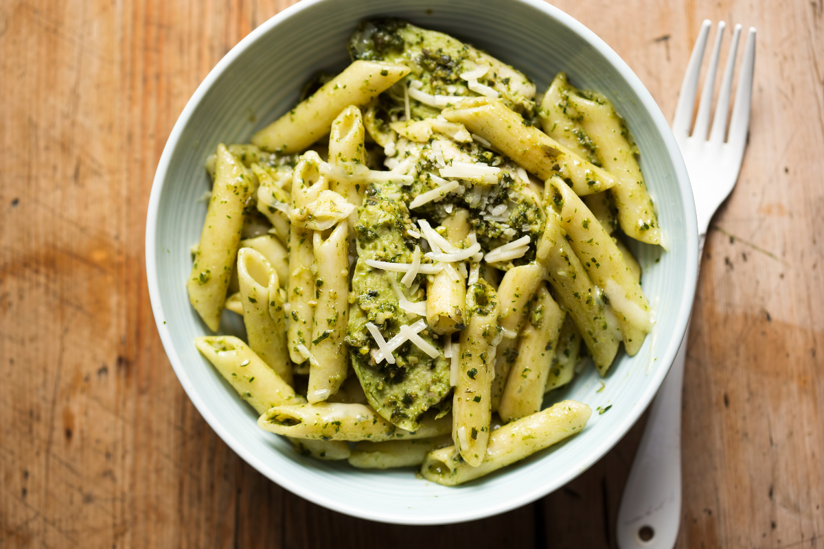 Rustic garlic parmesan chicken pasta on a wooden serving platter.