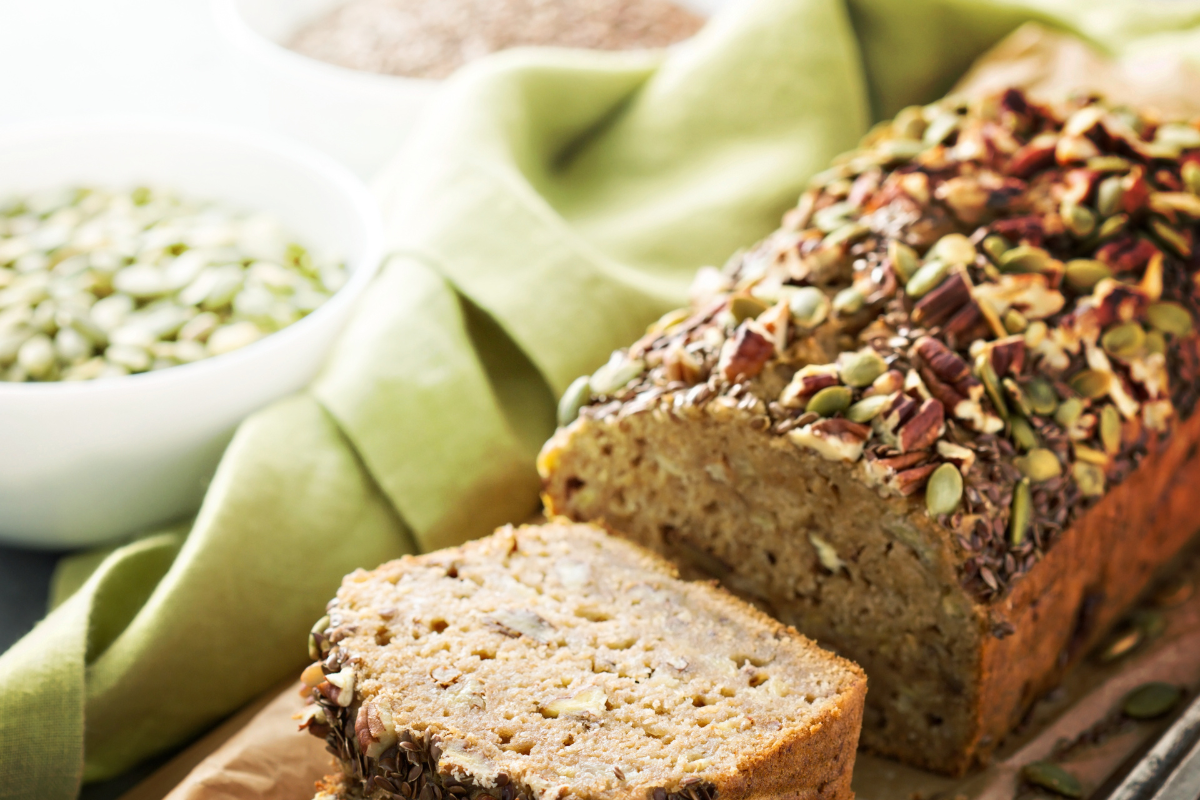 Gluten-free bread loaf on wooden cutting board - keyphrase: gluten-free bread