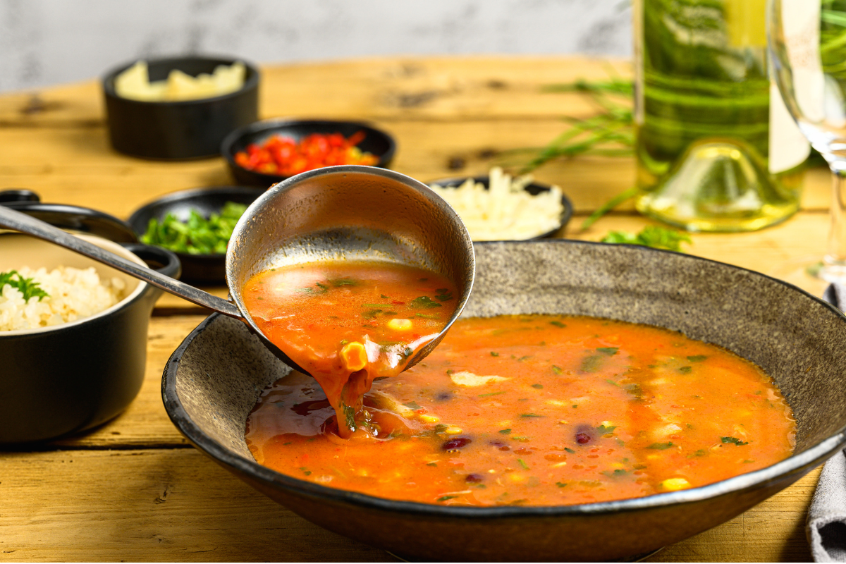 Ladle pouring lasagna soup